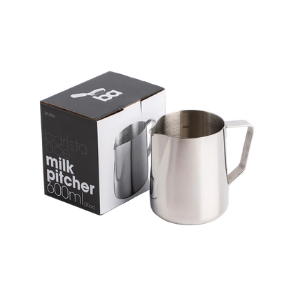 Stainless steel milk pitcher with packaging on a clear background