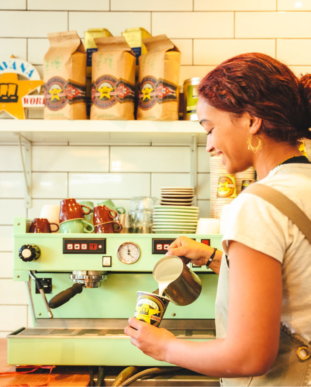 Customer pouring coffee at their venue